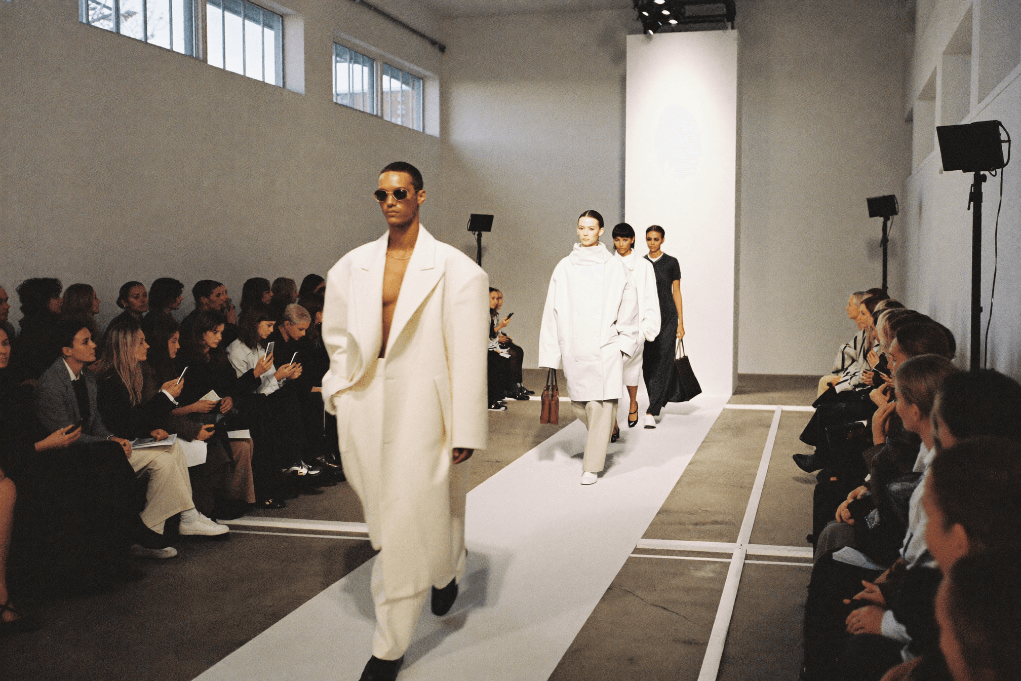 Copenhagen Fashion Week runway show — Scandinavian minimalist venue with models in structured Nordic apparel